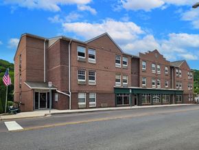 Lonaconing apartment for rent - a brick building with an flag in front of a street