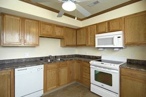 Urbana apartment for rent - a kitchen with white appliances and wooden cabinets