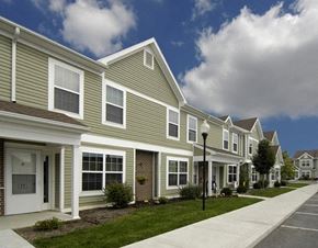 Urbana apartment for rent - a row of houses with a sidewalk in front of them