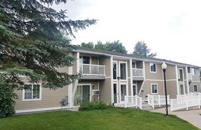 Munising apartment for rent - an apartment building with a yard and stairs