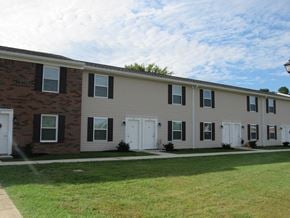 Thurman apartment for rent - a large apartment building with white doors and a lawn