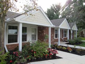 Bidwell apartment for rent - a front porch with flowers in front of a brick house