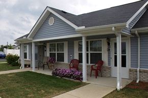 West Union apartment for rent - a blue house with rocking chairs on a porch