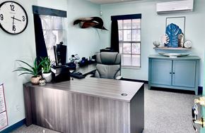 Haines City apartment for rent - A reception desk with a clock on the wall above it.