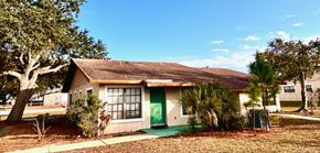 Haines City apartment for rent - A house with a green door and a brown roof.