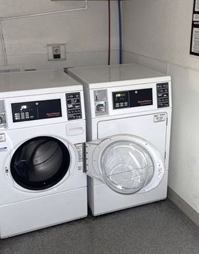 Taylorville apartment for rent - two washing machines sitting next to each other in a laundromat