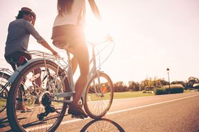 Cross Lanes apartment for rent - a man and a woman riding a bike down a street