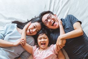 Virden apartment for rent - a woman and two children laying on a bed
