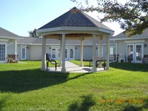 Fowlerville apartment for rent - a gazebo in a yard in front of a house