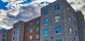 Parkersburg apartment for rent - A large building with many windows and a grey stone exterior.