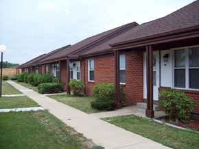 Galion apartment for rent - a row of brick houses with a sidewalk and grass
