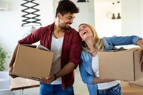 Vandalia apartment for rent - a couple laughing while holding boxes in a room