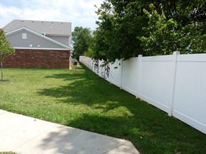 Belpre apartment for rent - a white fence in a yard in front of a house