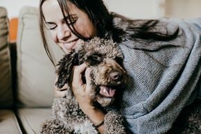 Virden apartment for rent - a woman holding a dog on a couch