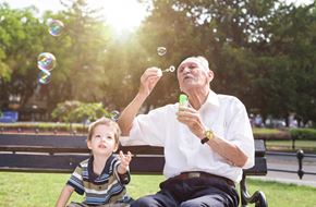 Shepherdstown apartment for rent - an older man and a child blowing bubbles in a park