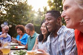 Leroy, Genesee County apartment for rent - a group of people sitting around a table talking and eating food