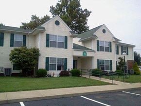 Jamestown apartment for rent - a white house with green shutters and a lawn