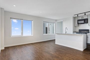 Washington apartment for rent - A spacious kitchen with a bar counter and a window.