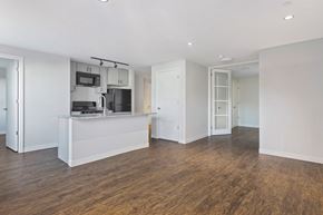 Washington apartment for rent - A kitchen with a white countertop and wooden floors.