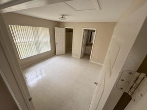 Fellsmere apartment for rent - A room with a white tile floor and a window with blinds.