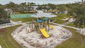 Fellsmere apartment for rent - A playground with a yellow slide and a green roofed pavilion.
