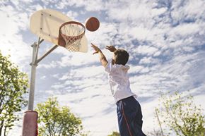 Labelle apartment for rent - A boy in a white shirt and blue shorts is shooting a basketball into a hoop.