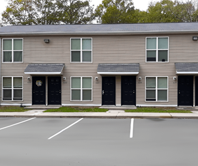 Waverly apartment for rent - an apartment building with black doors and a parking lot