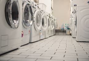 Selbyville apartment for rent - A row of white front load washing machines in a laundromat.
