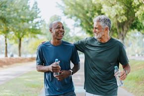 Mercer apartment for rent - Two men are walking and talking in a park.