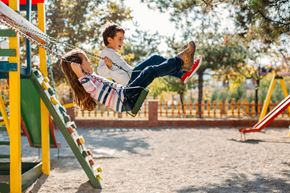 Labelle apartment for rent - A child is swinging on a swing at a playground.