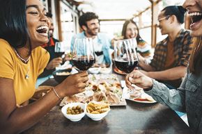 Sebring apartment for rent - A group of people are enjoying a meal and drinks together at a table.