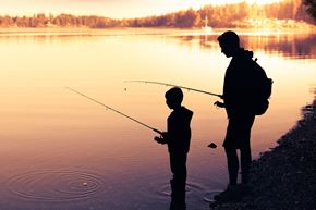 Labelle apartment for rent - A man and a child are fishing by the water.
