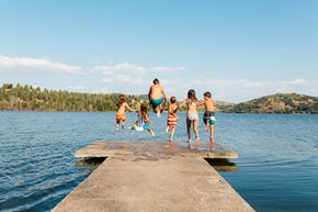 Sebring apartment for rent - A group of people jumping into a lake from a concrete pier.