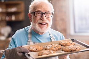Freeport apartment for rent - An elderly man with glasses and a beard is holding a tray of freshly baked cookies.