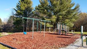 Munising apartment for rent - a playground with a swing set in a park