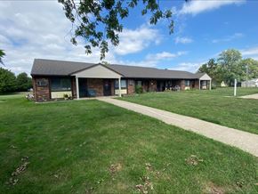 Argenta, Macon County apartment for rent - a building with a gray roof and a sidewalk in front of it