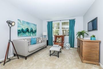 Oxnard apartment for rent - A living room with a couch, chair, and a painting on the wall.