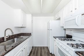 Redlands apartment for rent - a white kitchen with white appliances and white cabinets