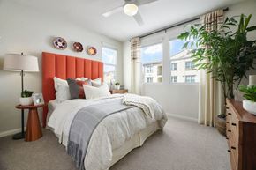 Riverside apartment for rent - A bedroom with a large bed and a window with curtains.
