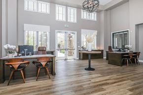 Oxnard apartment for rent - A modern office space with wooden floors and furniture.