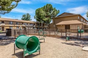 Lancaster apartment for rent - A playground with a green slide and a brown building in the background.