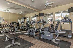 Clovis townhouse for rent - A gym with treadmills, weights, and exercise equipment.
