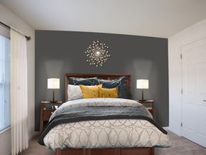 West Long Branch apartment for rent - A bedroom with a large bed and a chandelier.
