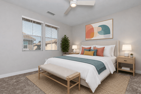 Clovis townhouse for rent - A bedroom with a bed, nightstands, and a ceiling fan.
