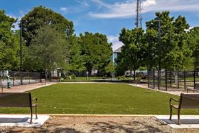 Lawrenceville apartment for rent - A park with a green field, trees, and benches.