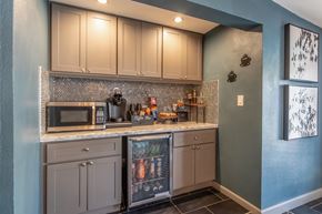 Visalia apartment for rent - A kitchen with a blue wall and a fridge with a picture of a family on it.