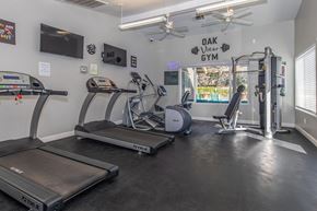 Visalia apartment for rent - A gym with treadmills, exercise bikes, and a weight machine.
