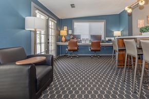 Visalia apartment for rent - A living room with a grey carpet and a black leather sofa.