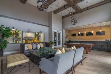 Oxnard apartment for rent - A living room with a pool table and a bar area.