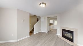 Manchester apartment for rent - A living room with a fireplace and a staircase.